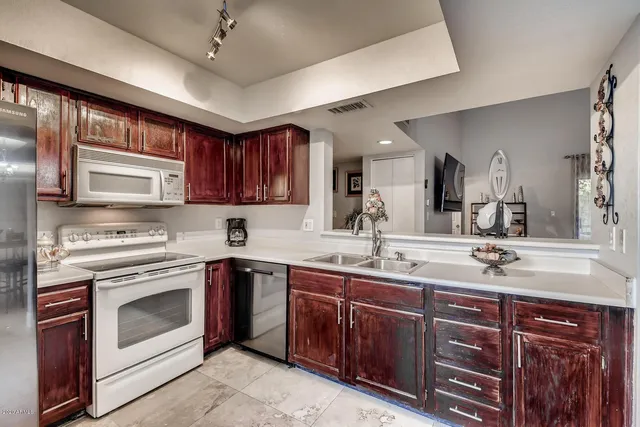 a kitchen with a sink stove and cabinets