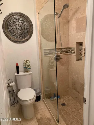 a bathroom with a toilet and a shower