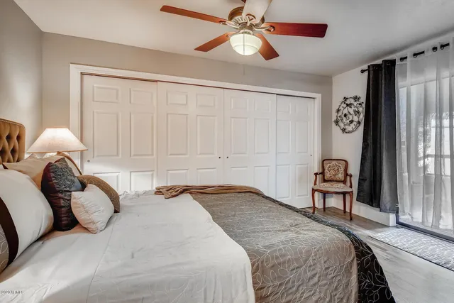 a bedroom with a bed and a chandelier