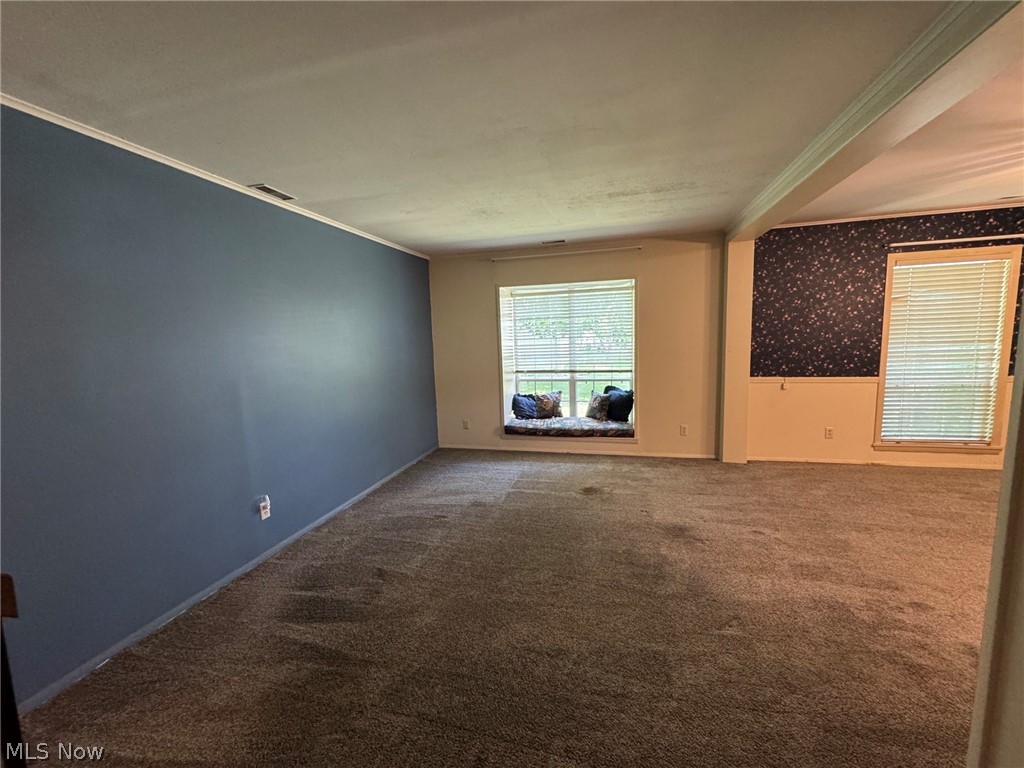 7294 Fox Mill Road, Unit 19D Mentor, OH 44060 - Photo 5 of 27 Spacious living room featuring carpeting, a built-in window seat, and multiple windows with blinds