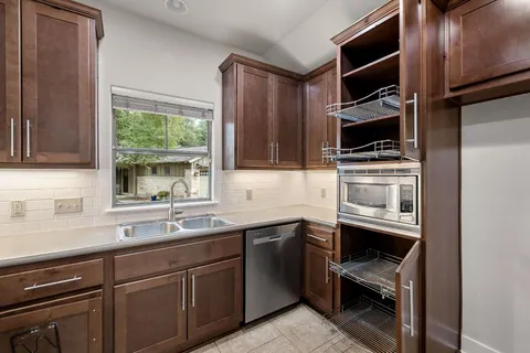 a kitchen with stainless steel appliances a stove sink and cabinets