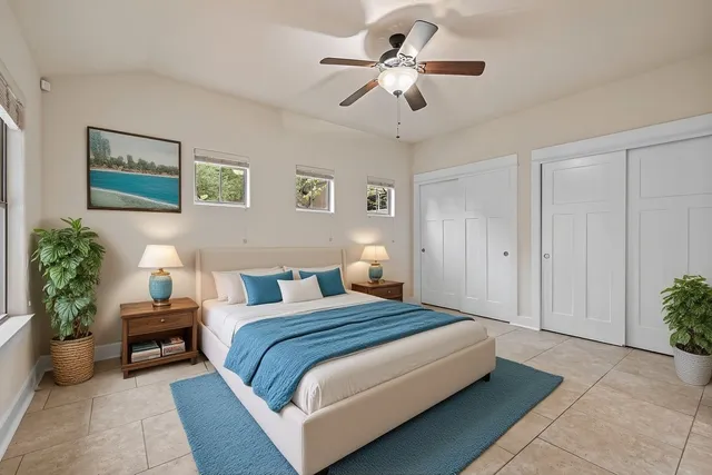 a spacious bedroom with a bed and a chandelier