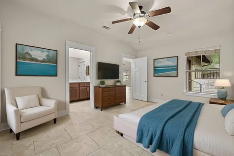 a view of an empty room with cabinet and a ceiling fan