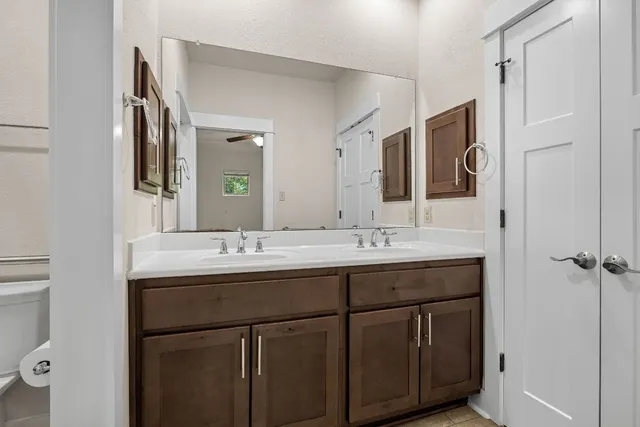 a bathroom with a double vanity sink and mirror