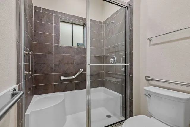 a bathroom with a shower and a toilet