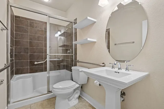 a bathroom with a sink toilet and shower