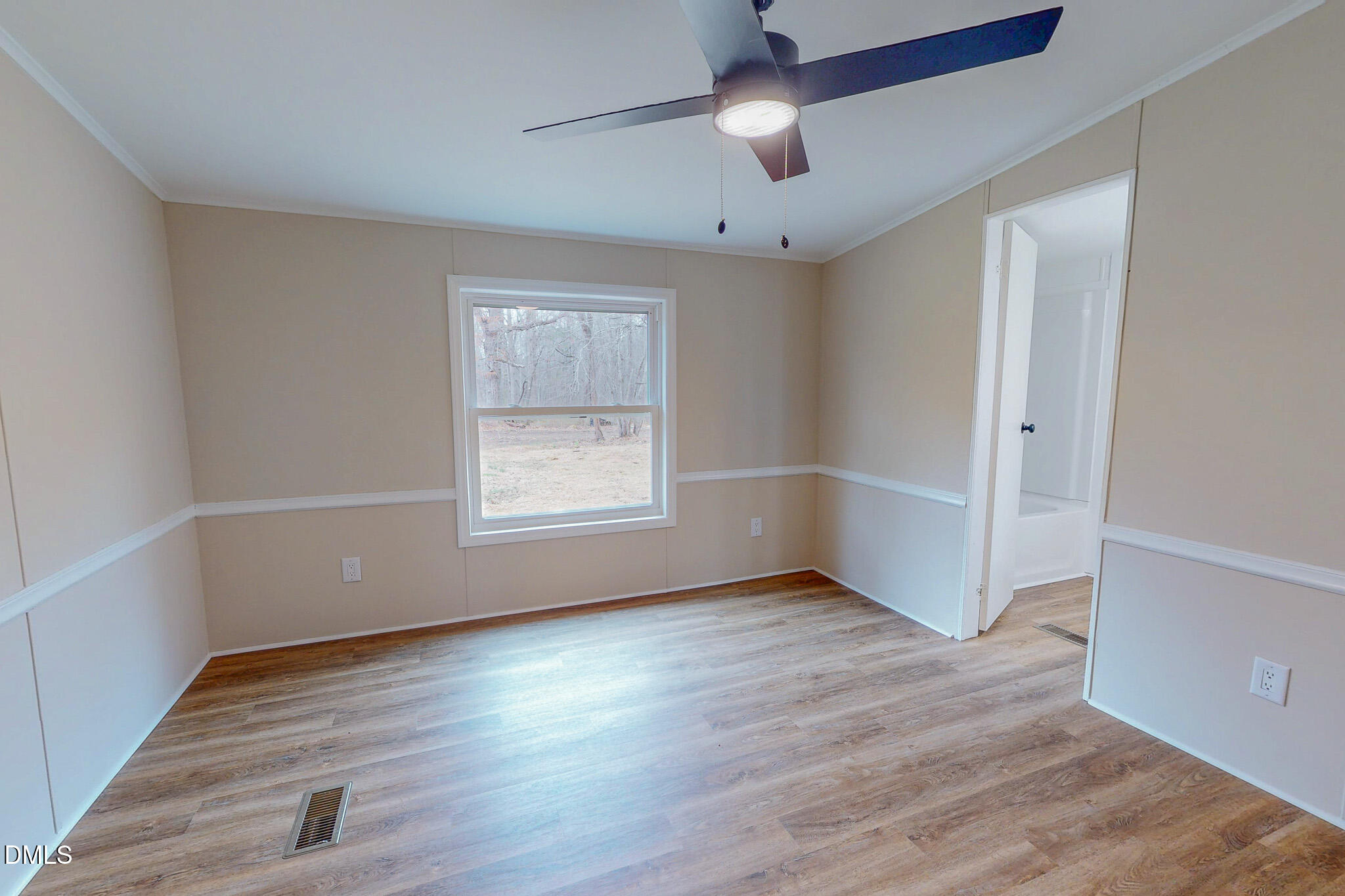 67 Halifax Road Roxboro, NC 27574 - Photo 16 of 48 an empty room with wooden floor chandelier fan and windows