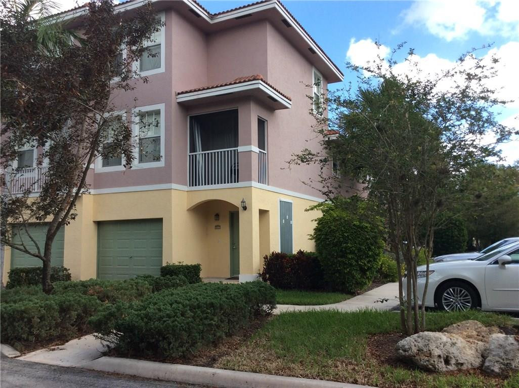 6498 West Sample Road, Unit 6498 Coral Springs, FL 33067 - Photo 1 of 19 a front view of a house with a garden