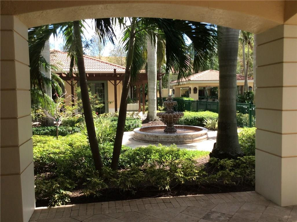 6498 West Sample Road, Unit 6498 Coral Springs, FL 33067 - Photo 15 of 19 a view of backyard with swimming pool and green space