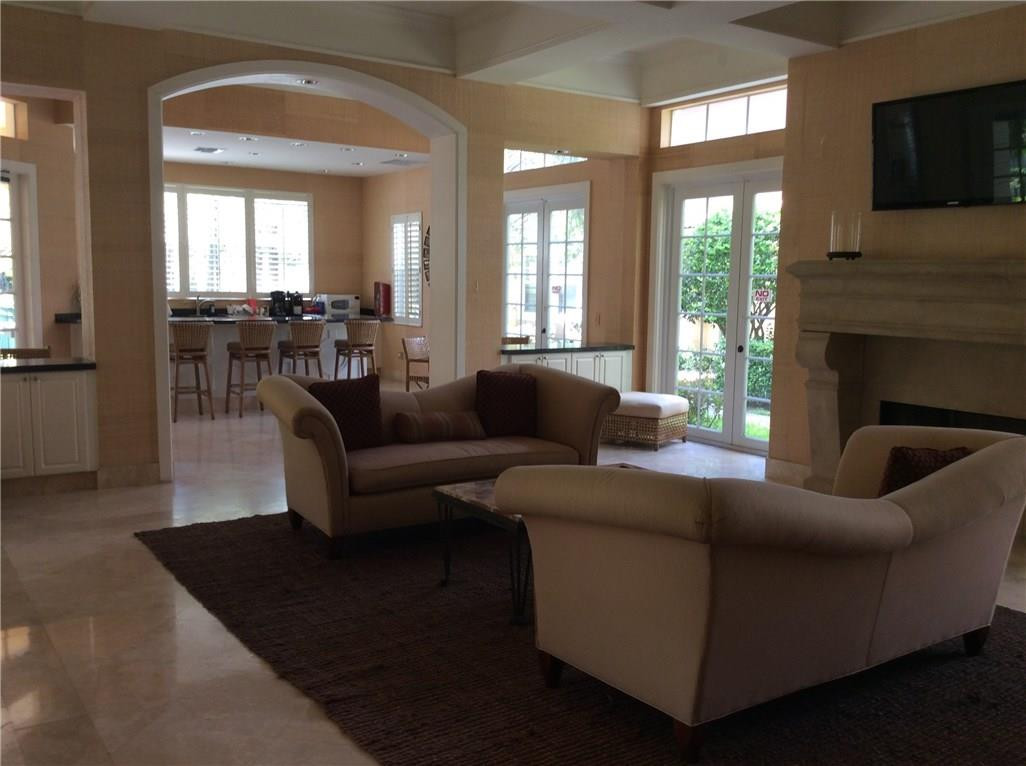6498 West Sample Road, Unit 6498 Coral Springs, FL 33067 - Photo 18 of 19 a living room with furniture and a fireplace