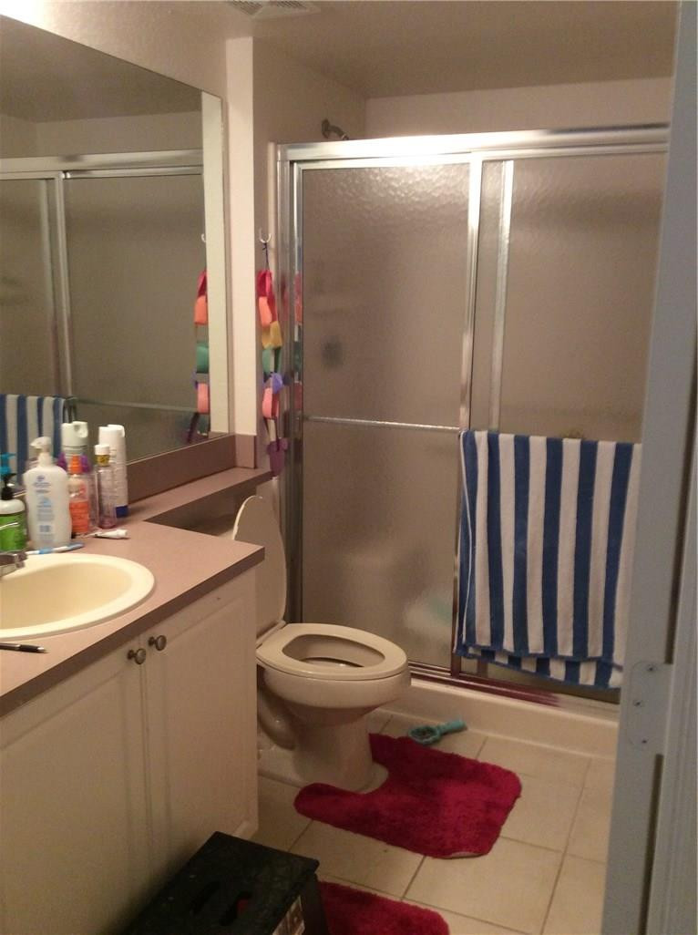 6498 West Sample Road, Unit 6498 Coral Springs, FL 33067 - Photo 8 of 19 a bathroom with a sink toilet and shower
