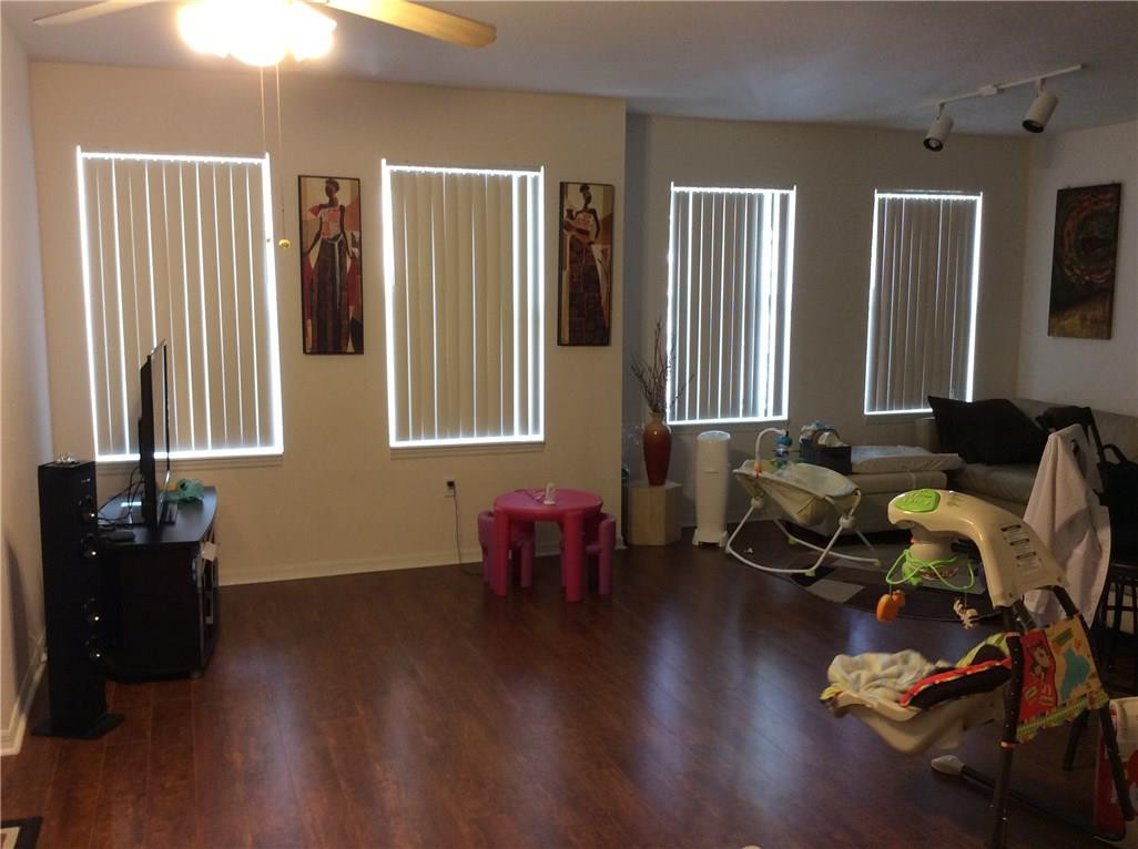 6498 West Sample Road, Unit 6498 Coral Springs, FL 33067 - Photo 10 of 19 a living room with furniture and wooden floor