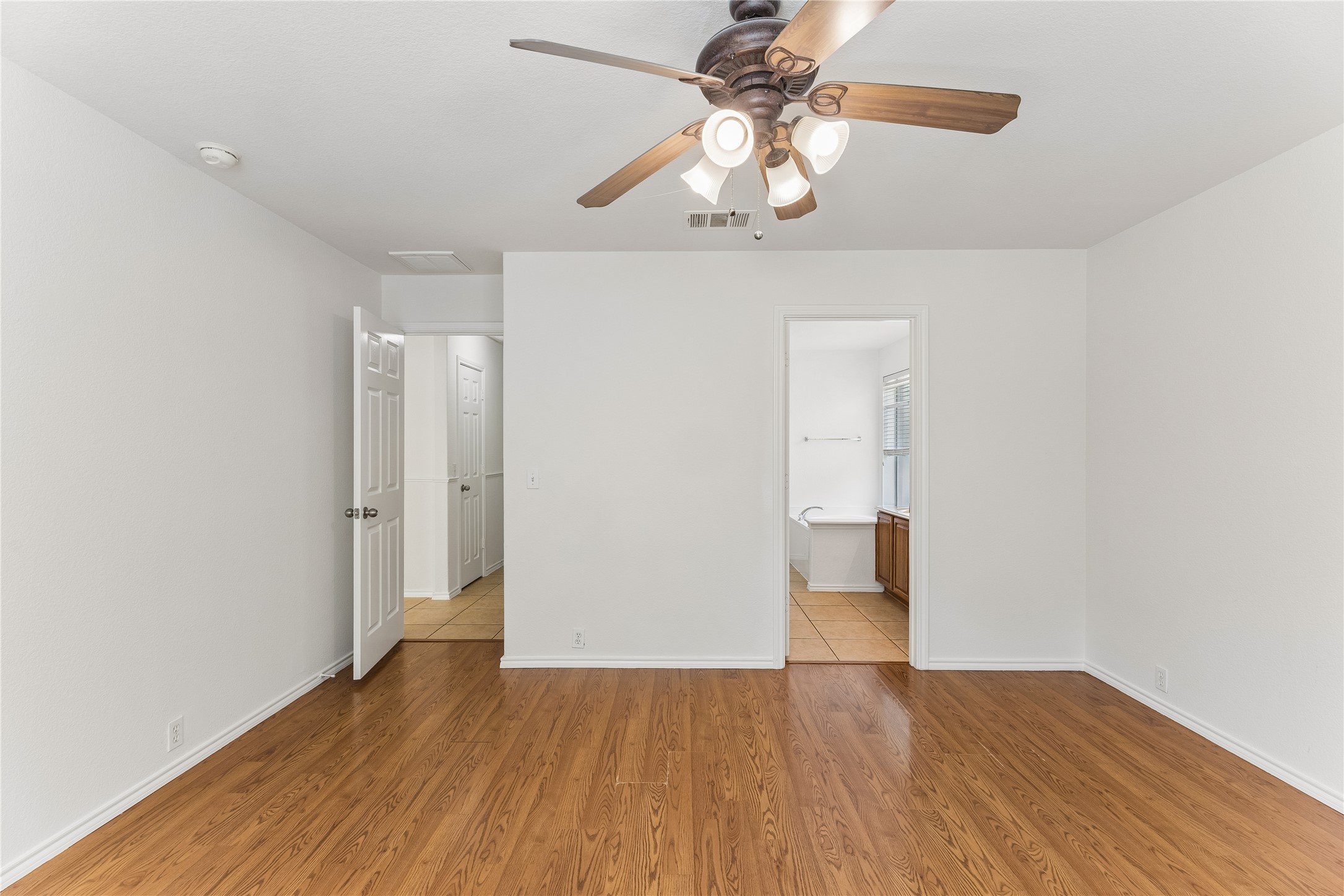 2372 Paradise Ridge Drive Round Rock, TX 78665 - Photo 17 of 40 Hardwood floors and a ceiling fan create a comfortable atmosphere in this open living area.