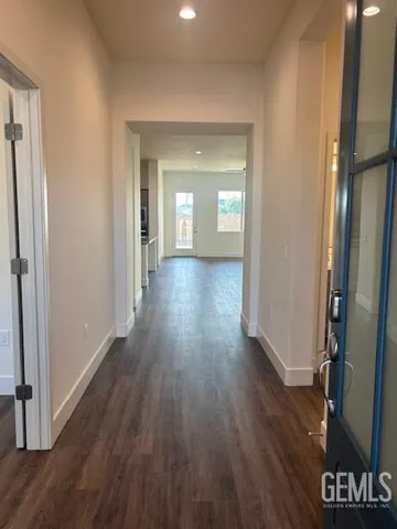 a view of a room with wooden floor and a bathroom