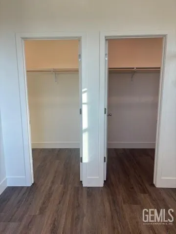 an empty room with wooden floor and closet