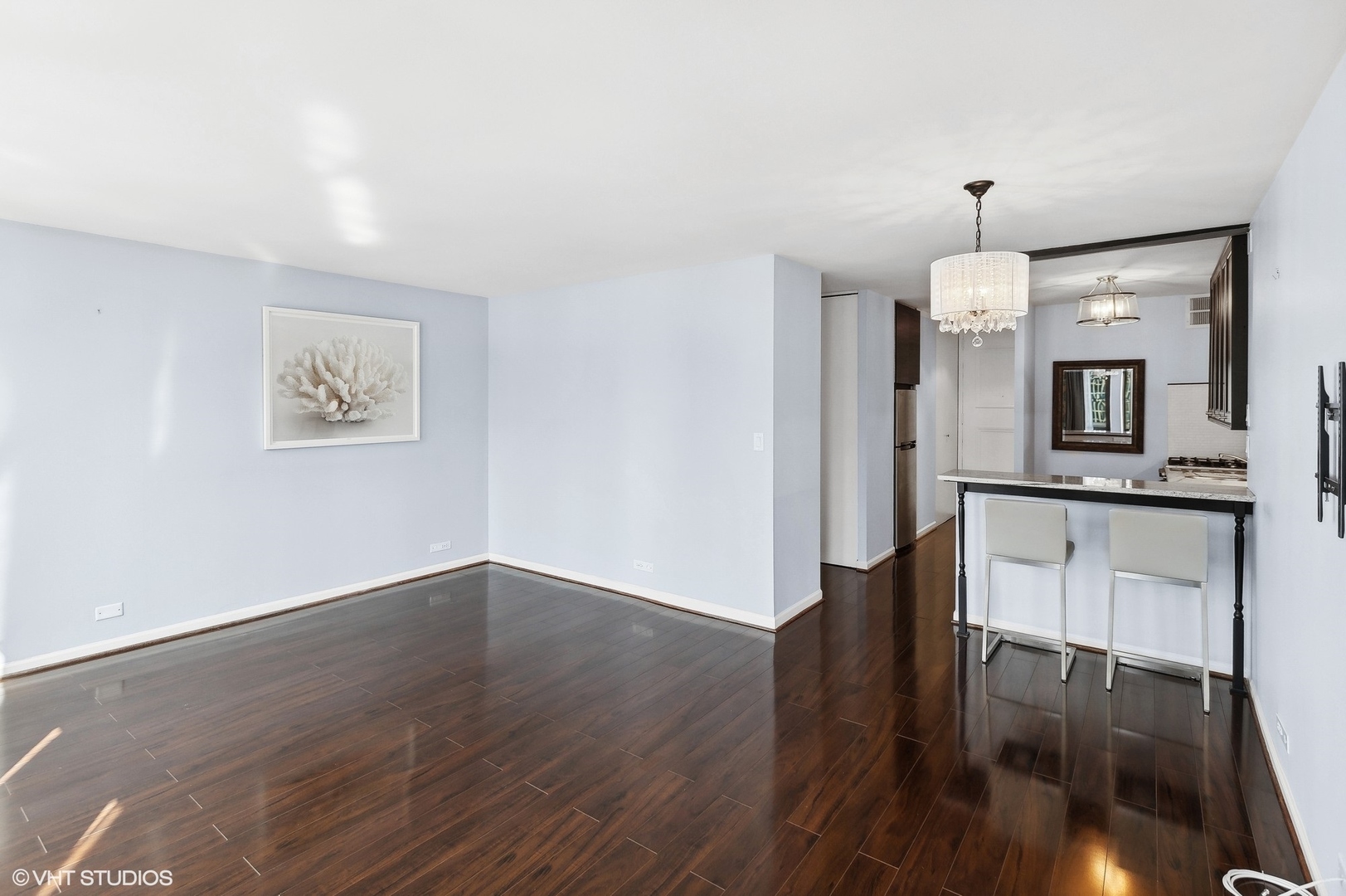 1 East Scott Street, Unit 1006 Chicago, IL 60610 - Photo 2 of 15 a workspace with wooden floor fireplace and dining room