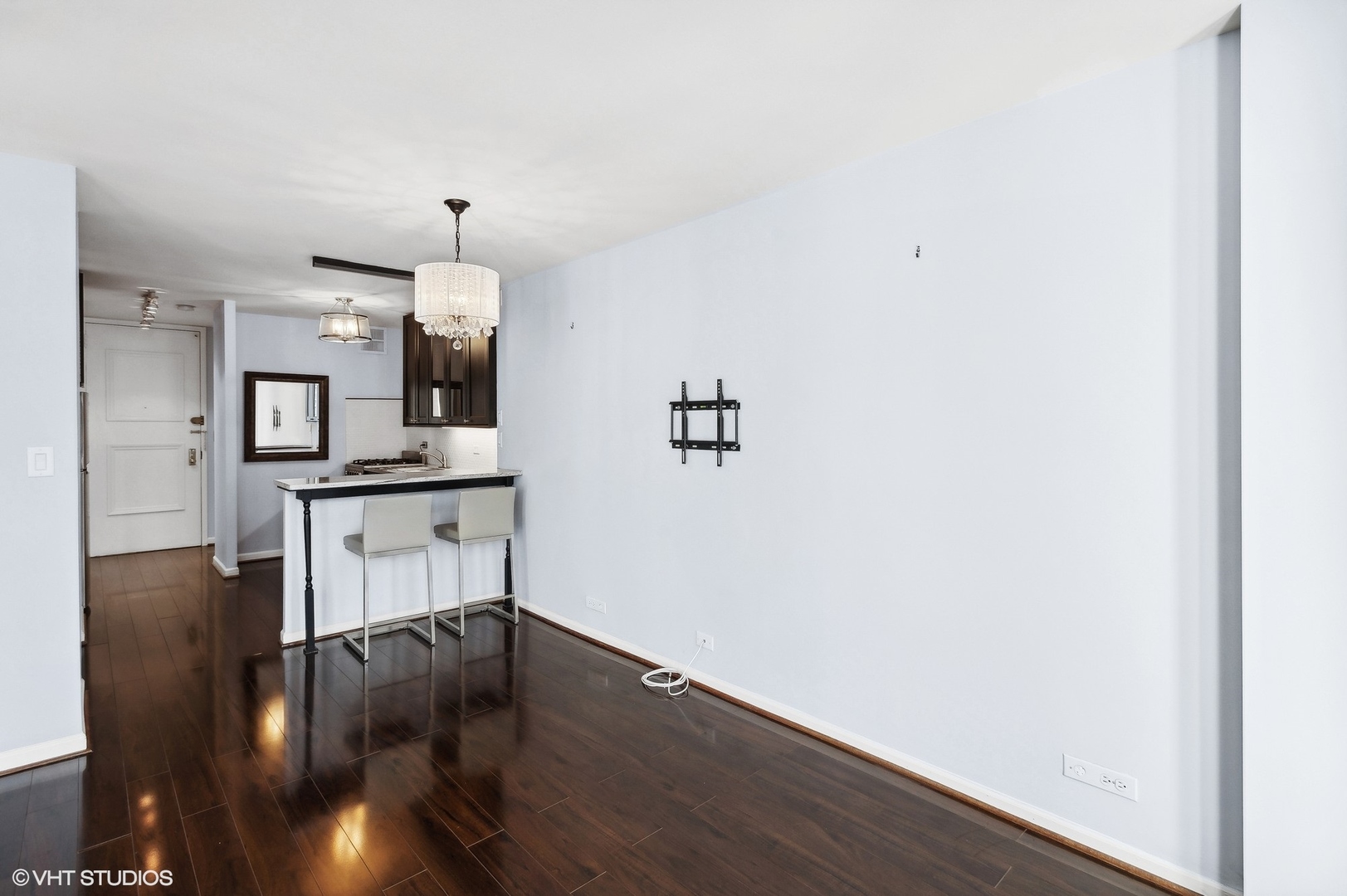 1 East Scott Street, Unit 1006 Chicago, IL 60610 - Photo 4 of 15 a view of a kitchen with cabinets and wooden floor