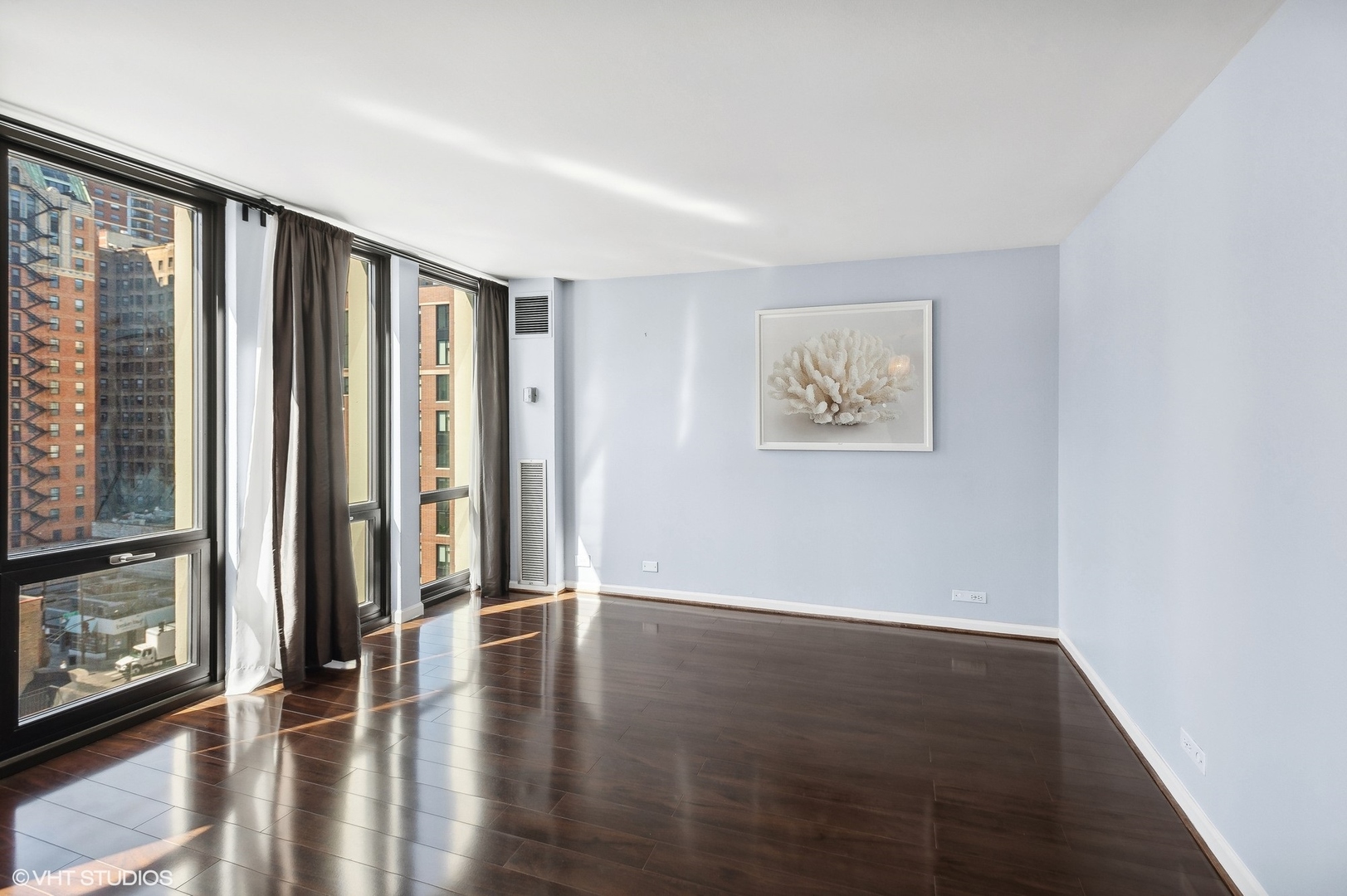 1 East Scott Street, Unit 1006 Chicago, IL 60610 - Photo 5 of 15 wooden floor in an empty room with a window
