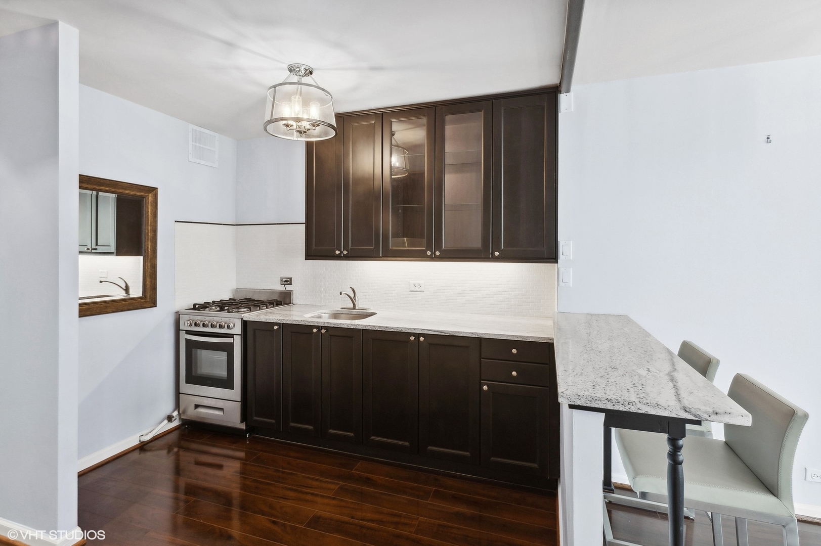 1 East Scott Street, Unit 1006 Chicago, IL 60610 - Photo 7 of 15 a kitchen with a sink and stainless steel appliances