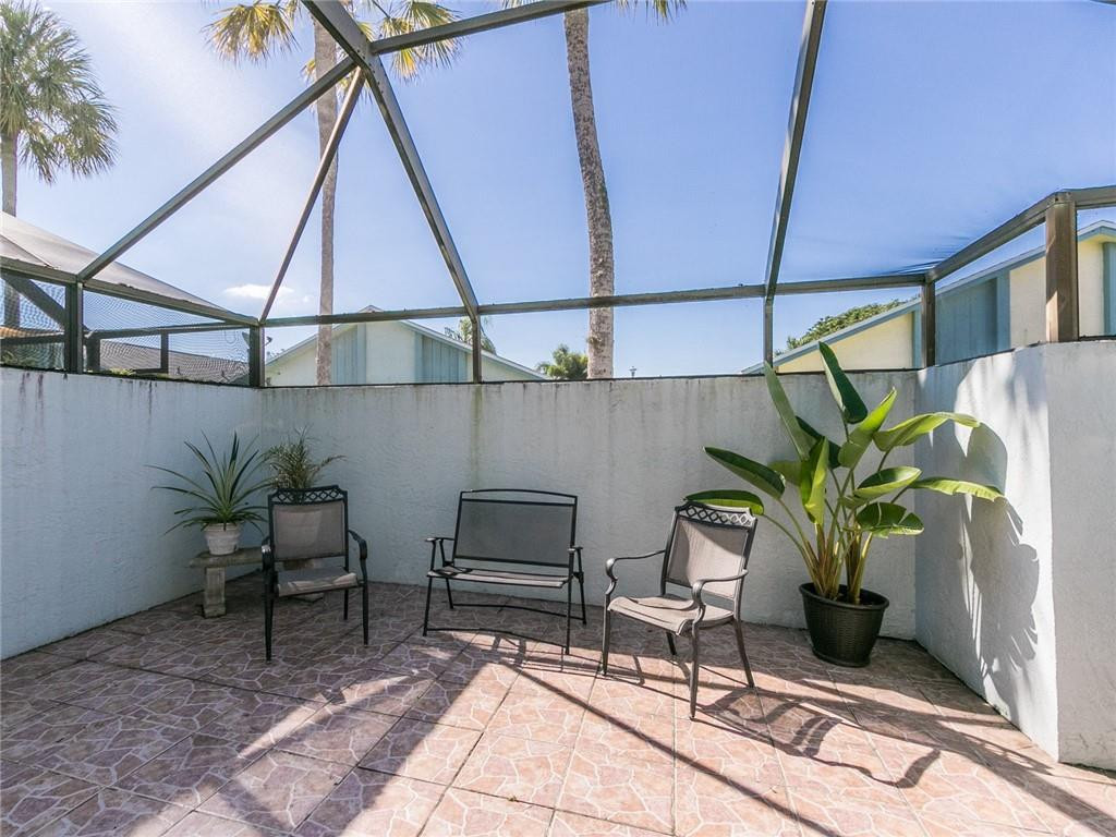9112 Southwest 21st Court, Unit F Boca Raton, FL 33428 - Photo 11 of 34 a vase of flowers sitting on a table in a patio