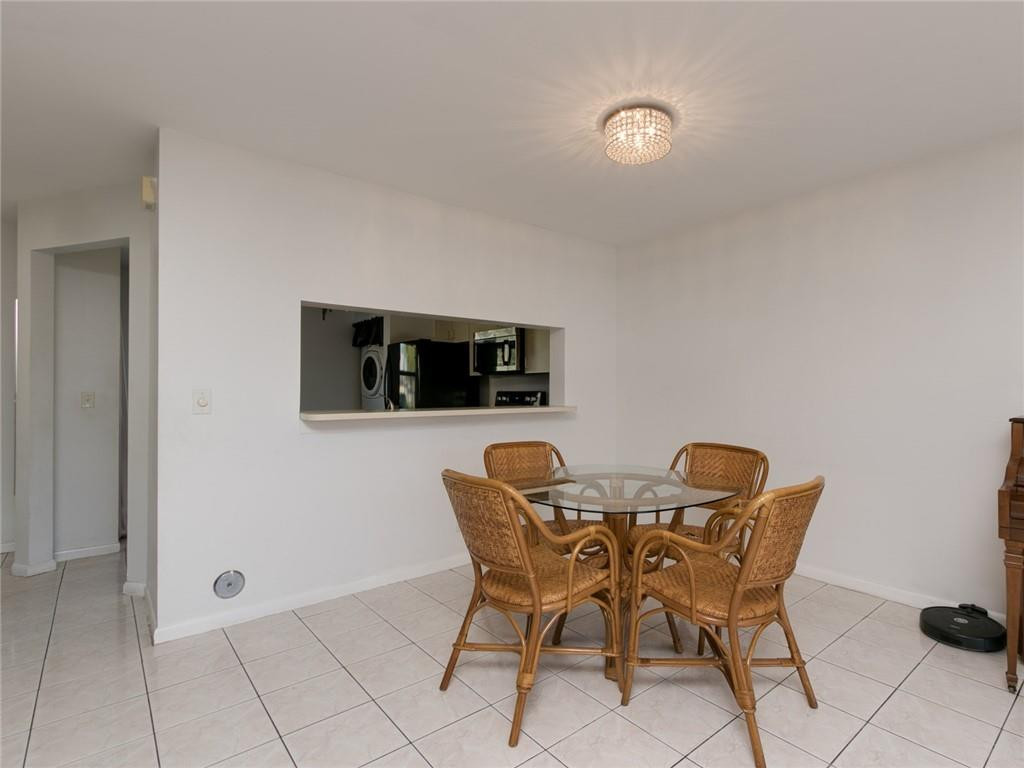 9112 Southwest 21st Court, Unit F Boca Raton, FL 33428 - Photo 12 of 34 a dining room with furniture and window