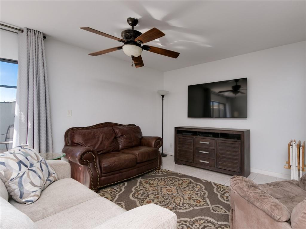 9112 Southwest 21st Court, Unit F Boca Raton, FL 33428 - Photo 15 of 34 a living room with furniture a flat screen tv and a fireplace
