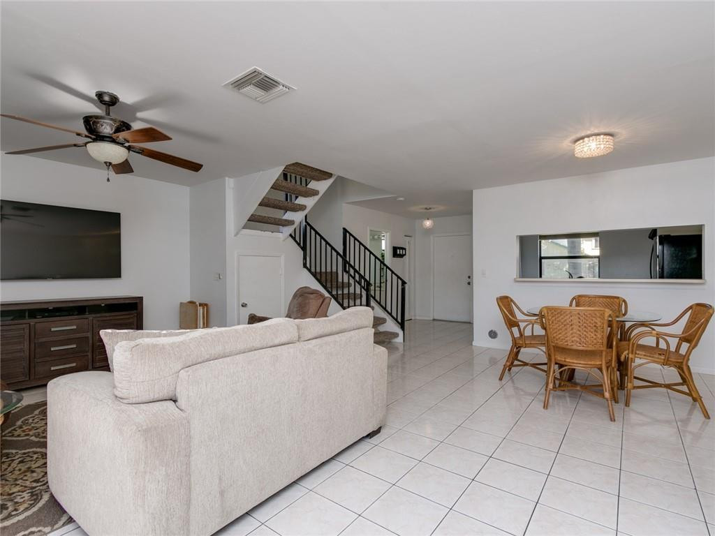 9112 Southwest 21st Court, Unit F Boca Raton, FL 33428 - Photo 17 of 34 a living room with furniture and a flat screen tv