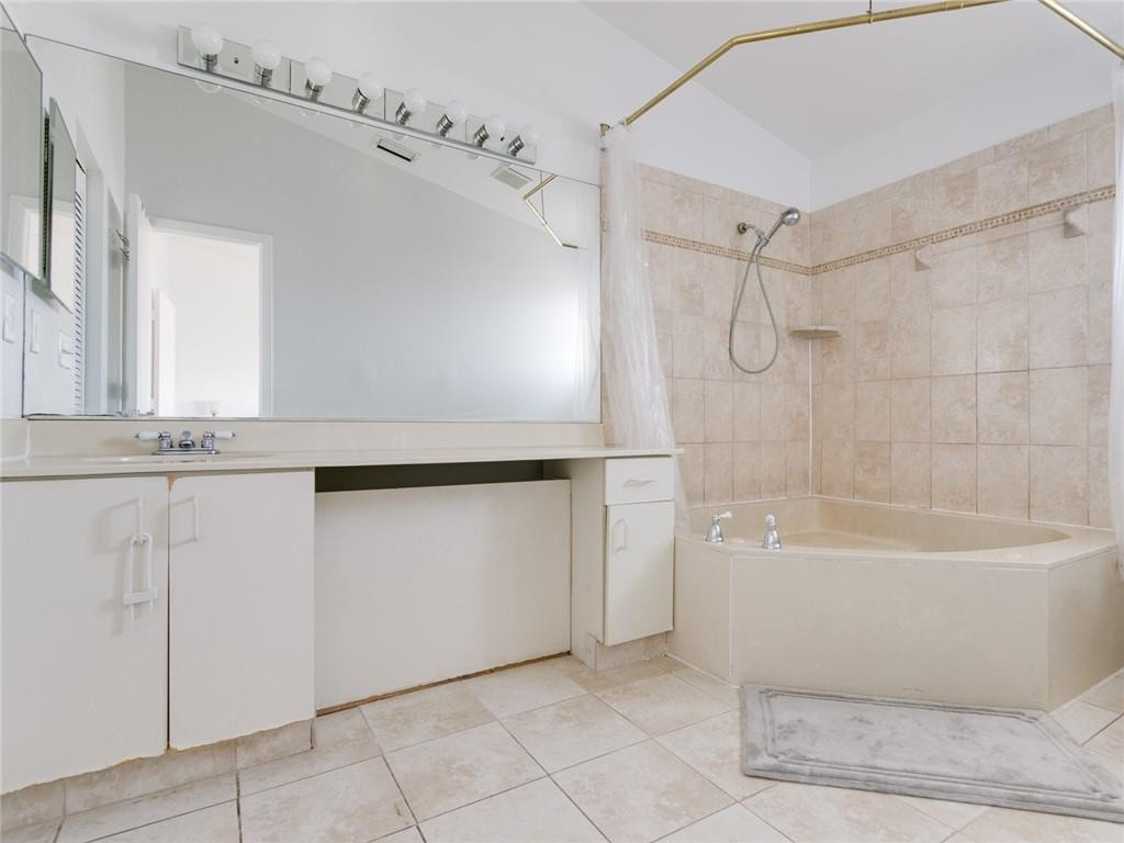 9112 Southwest 21st Court, Unit F Boca Raton, FL 33428 - Photo 20 of 34 a bathroom with a bathtub and a shower