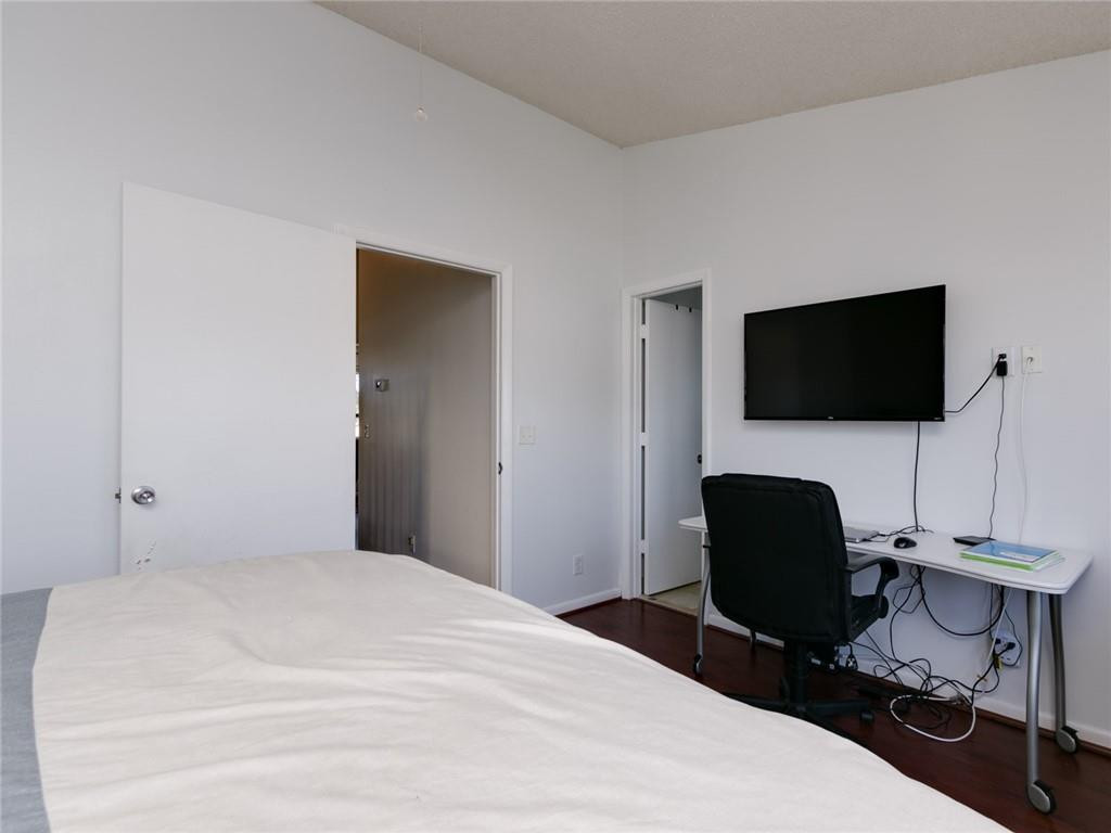 9112 Southwest 21st Court, Unit F Boca Raton, FL 33428 - Photo 21 of 34 a bedroom with a bed and a flat screen tv