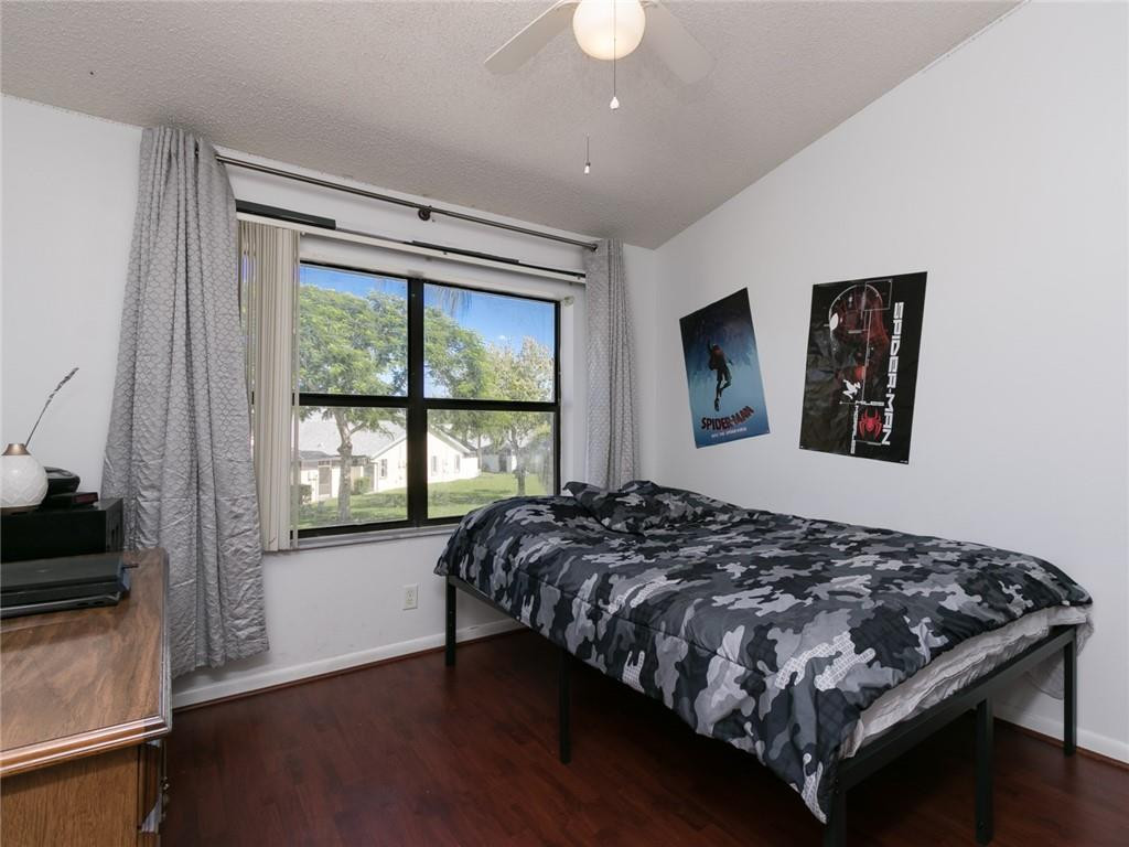 9112 Southwest 21st Court, Unit F Boca Raton, FL 33428 - Photo 22 of 34 a bedroom with a bed and a window