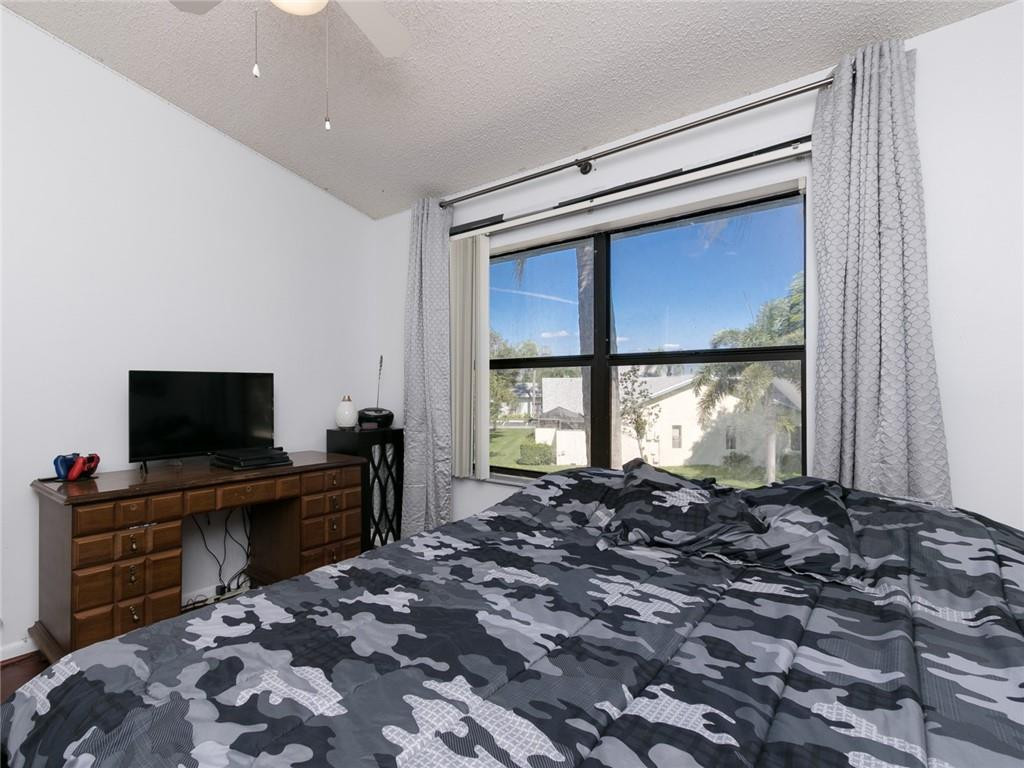 9112 Southwest 21st Court, Unit F Boca Raton, FL 33428 - Photo 23 of 34 a living room with furniture and a flat screen tv