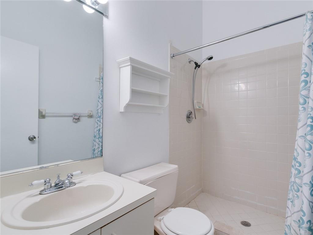 9112 Southwest 21st Court, Unit F Boca Raton, FL 33428 - Photo 25 of 34 a bathroom with a sink toilet and shower