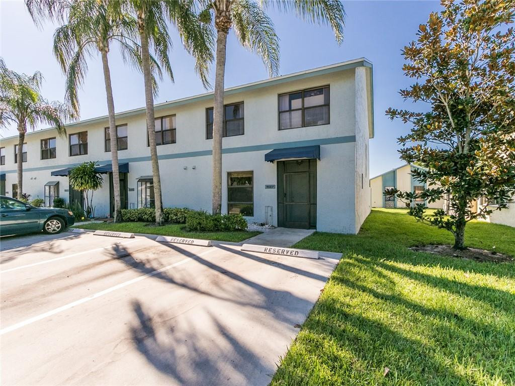9112 Southwest 21st Court, Unit F Boca Raton, FL 33428 - Photo 33 of 34 a front view of a house with a yard and potted plants