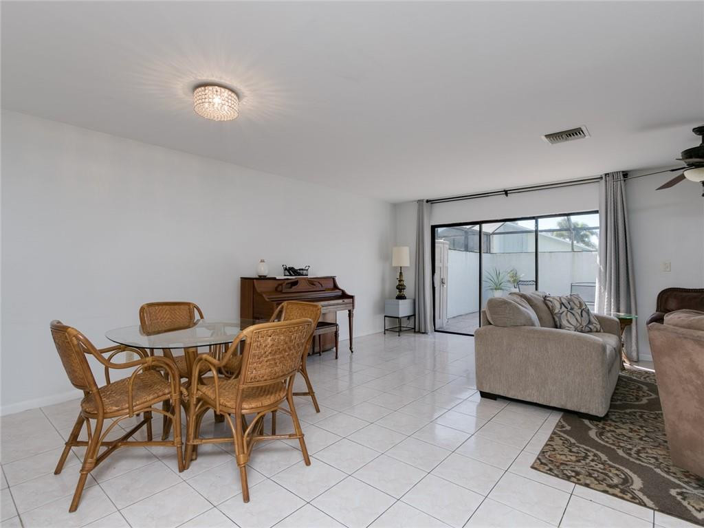 9112 Southwest 21st Court, Unit F Boca Raton, FL 33428 - Photo 8 of 34 a living room with furniture and a large window