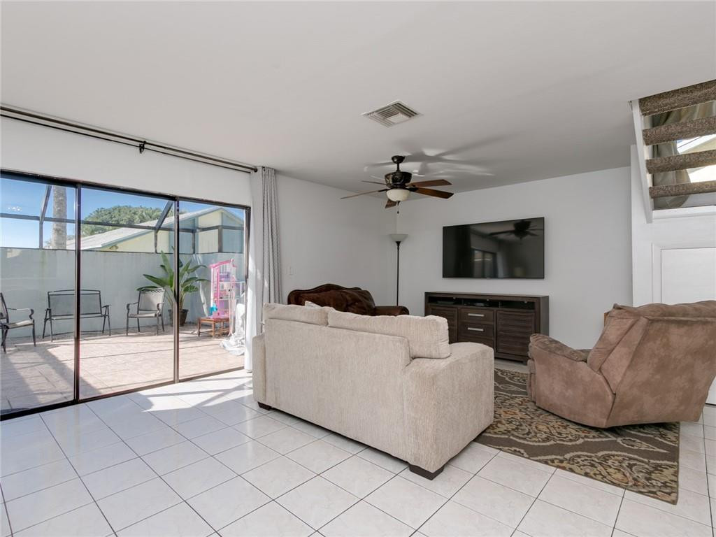9112 Southwest 21st Court, Unit F Boca Raton, FL 33428 - Photo 9 of 34 a living room with furniture and a flat screen tv