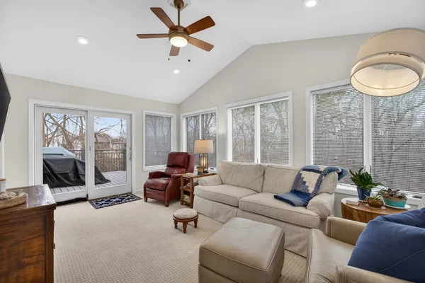 a living room with furniture and a flat screen tv with wooden floor
