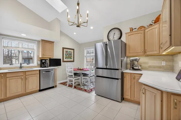 a kitchen with stainless steel appliances granite countertop a refrigerator and a stove top oven