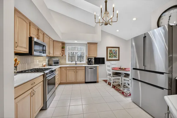 a kitchen with stainless steel appliances granite countertop a refrigerator sink and cabinets