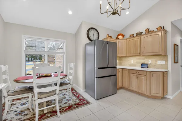 a kitchen with stainless steel appliances granite countertop a refrigerator and a stove top oven