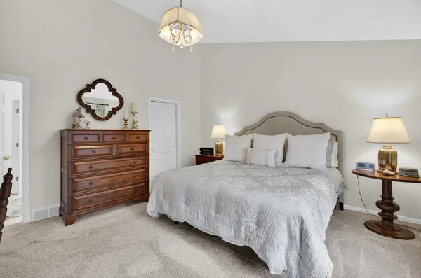 a bedroom with a bed and a table