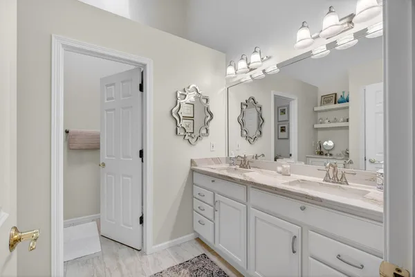 a bathroom with a double vanity sink mirror and