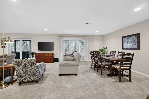 a living room with furniture a flat screen tv and a window