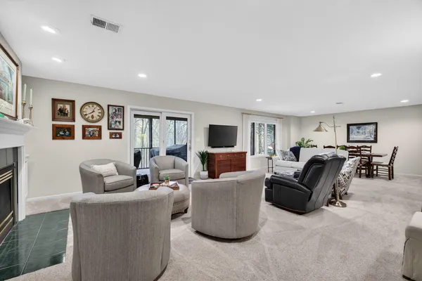 a living room with furniture a flat screen tv and a fireplace