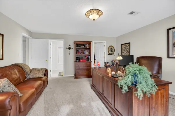 a bathroom with a toilet a sink a mirror a shower a vanity and window