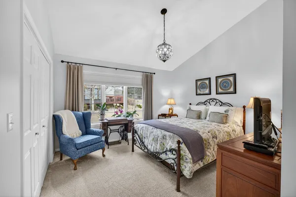 a bedroom with a bed couch and window