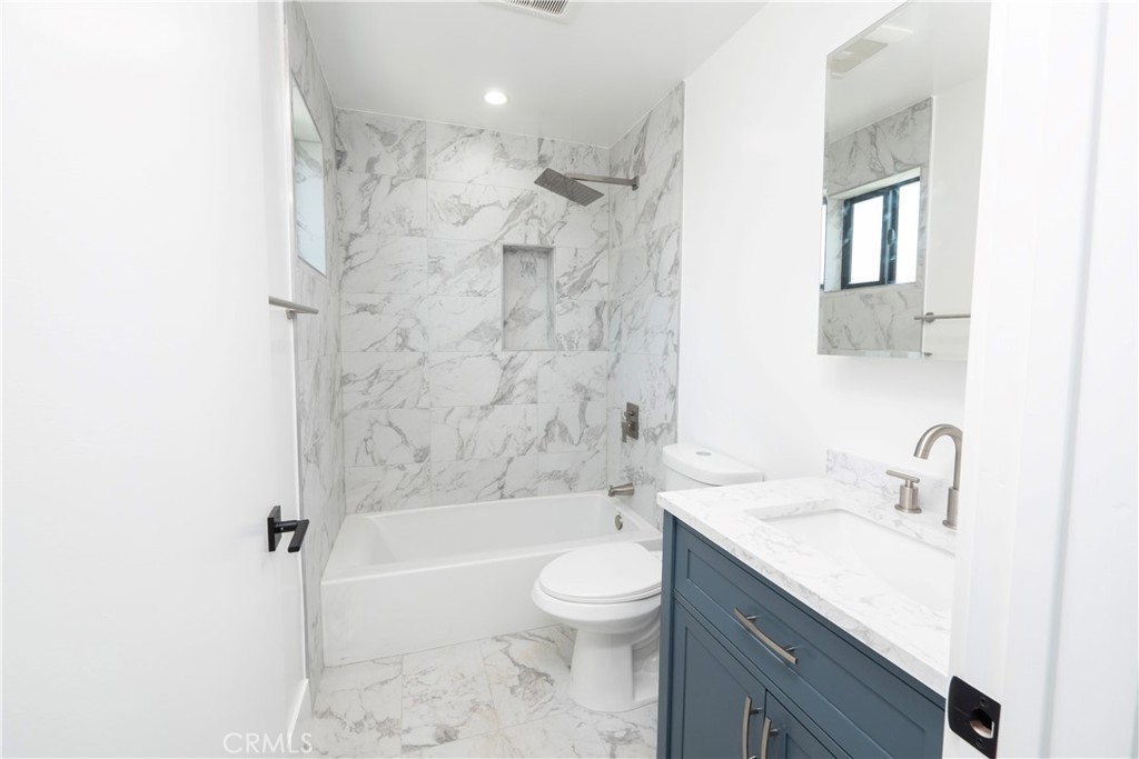 1571 Ricardo Street, Unit 2 Los Angeles, CA 90033 - Photo 15 of 29 a bathroom with a granite countertop sink a toilet and shower