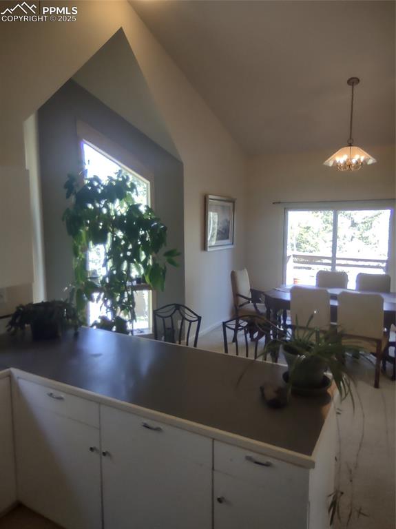 423 Ridge Road Divide, CO 80814 - Photo 15 of 48 a view of dining room and livingroom with furniture wooden floor a chandelier