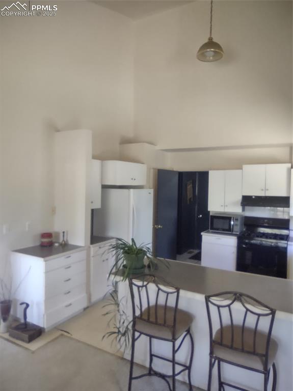 423 Ridge Road Divide, CO 80814 - Photo 16 of 48 a kitchen with a table and chairs in it
