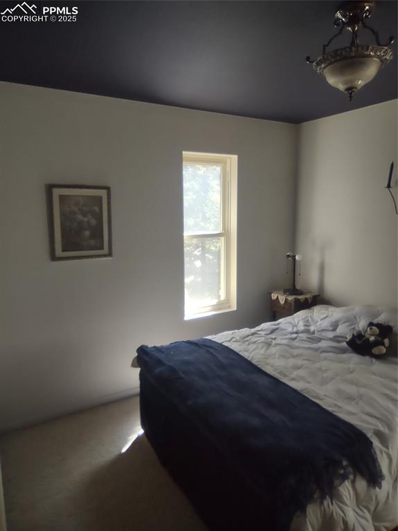 423 Ridge Road Divide, CO 80814 - Photo 27 of 48 a bedroom with a bed and a window