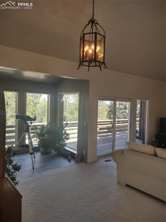 423 Ridge Road Divide, CO 80814 - Photo 10 of 48 a living room with furniture and a chandelier